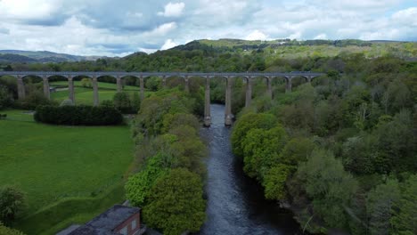 Aerial-view-Pontcysyllte-aqueduct-and-River-Dee-canal-narrow-boat-bride-in-Chirk-Welsh-valley-countryside-rising-forward