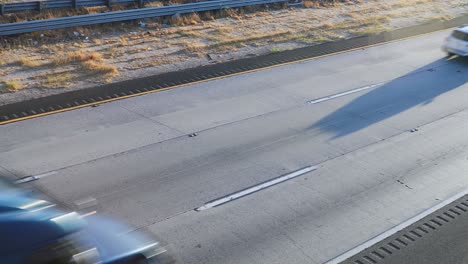 Fast-driving-vehicles-on-multi-lane-highway-in-California-on-sunny-day
