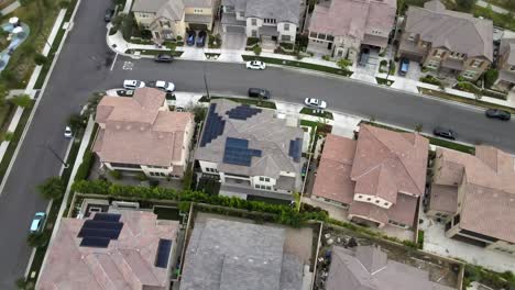 Orbit-drone,-over-house-with-solar-panels-on-roof,-Tustin,-California