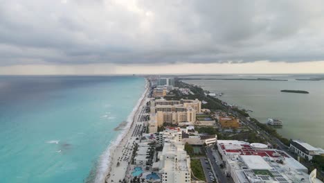 Atmospheric-Sky-Over-Sea,-Lagoon-Waters-of-Cancun-Hotel-Beach-Resort,-Mexico,-Established-Drone-Shot