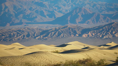 Mesquite-Undulating-Sand-Dunes-With-Mountains-In-Distant-Background