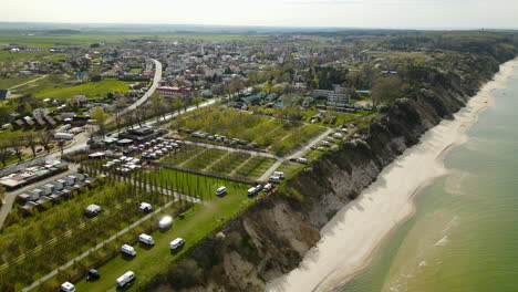 Aerial:-Camping-Area-beside-beautiful-sandy-beach-and-Baltic-Sea-in-Chłapowo,Poland