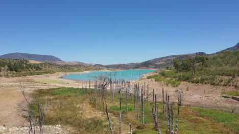 AERIAL---Man-made-lake-of-Zahara-de-la-Sierra,-Cadiz,-Spain,-scenic-shot-forward