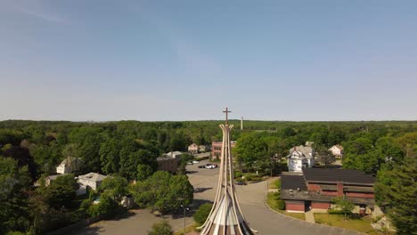 Aerial-descent-reveal-of-a-church-surrounded-by-trees-in-Weymouth,-Massachusetts