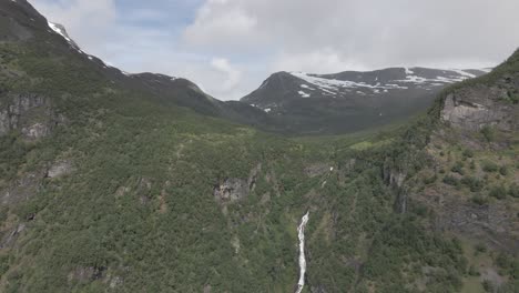 Slow-drone-shot-of-green-mountain-with-Bringefossen-in-Geiranger-fjord,-Norway