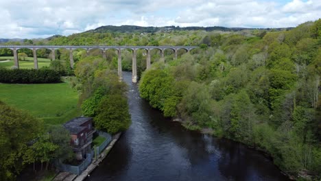 Aerial-view-Pontcysyllte-aqueduct-and-River-Dee-canal-narrow-boat-bride-in-Chirk-Welsh-valley-countryside-high-to-low