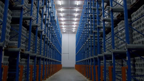 POV-Of-A-Person-Walking-In-Narrow-Aisle-Of-Warehouse-With-Pallet-Racking-System