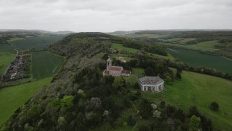 West-Wycombe-Hill-famous-landmark,-St-Lawrence-Church-Bucks-UK-Aerial-point-of-view-footage