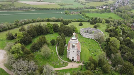 West-Wycombe-Hill-famous-landmark,-St-Lawrence-Church-Bucks-UK-drone-POV-4K