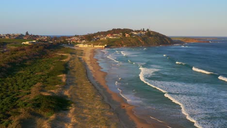Aerial-view-of-Foamy-Sea-Waves-at-Fishermans-Beach-In-Wollongong-at-sunset,-NSW,-Australia