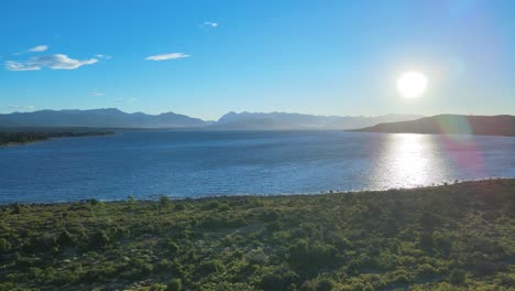 Aerial-view-of-the-Nahuel-Huapi-lake-and-the-radiant-sun-before-sunset