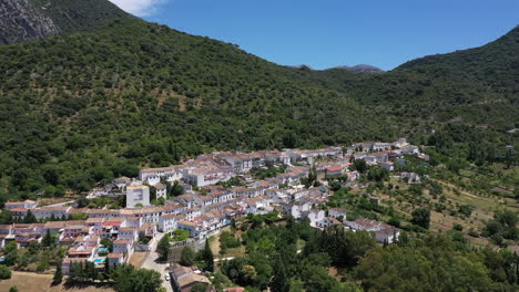 AERIAL---Village-of-Grazalema-in-Cadiz,-Andalusia,-Spain,-wide-shot-backwards