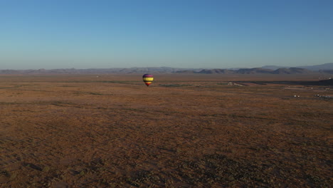 Flying-near-a-single-hot-air-balloon-over-Arizona-desert-landscape