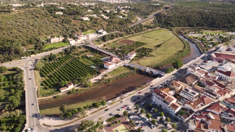 Rotating-aerial-pan-over-the-Arade-river-in-Silves,-Portugal