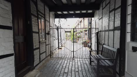 Old-Gated-alleyway-in-Eton-UK-with-bench-by-door