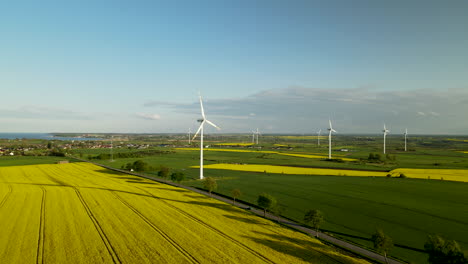 Stunning-rural-landscape-in-Poland-with-yellow-field-and-spinning-windmills