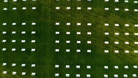 Aerial-View-Of-White-Chairs-In-Rows-On-The-Green-Field-During-The-Graduation-Event-Of-Puget-Sound-University-In-Tacoma,-Washington