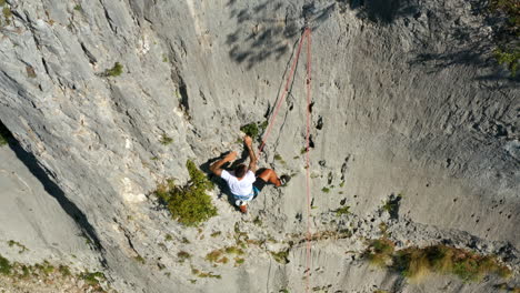 Athletic-Man-On-Harness-Climbing-On-Limestone-Canyon-Of-Vela-Draga-At-Summer-In-Vranja,-Croatia