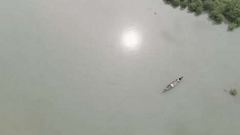 Beautiful-aerial-drone-shot-of-Indian-fisherman-on-a-wooden-canoe-boat