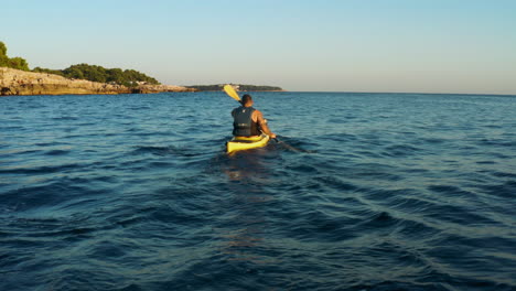 Man-In-Vest-Kayaking-On-A-Wavy-Ocean-Near-City-Of-Pula-In-Croatia’s-Istrian-Peninsula