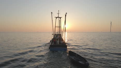 Side-trawler-heading-out-to-sea-during-sunrise-in-the-Netherlands