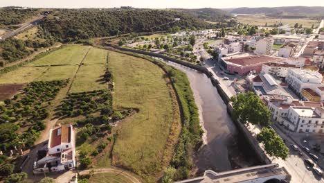 Backwards-flying-aerial-along-the-Arade-river-in-Silves-in-the-Portuguese-region-of-Algarve