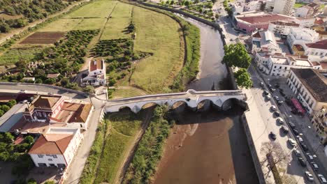 Slow-flyover-of-the-historic-arch-bridge-in-Silves,-Portugal