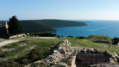 Blue-Sportback-Car-Positioned-At-Kamenjak-Peninsula-Overlooking-Adriatic-Sea-In-Istria,-Croatia