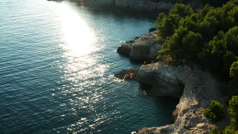 Tourists-On-The-Edge-Of-Cliff-Of-Seagull’s-Rocks-Beach-On-A-Sunny-Summer-Day-In-Stoja,-Pula,-Croatia