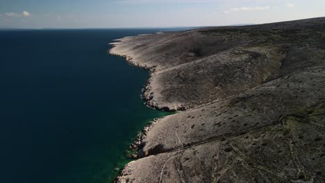 Backwards-reveal-shot-with-drone-of-the-coast-in-croatia-sea-adriatic-and-the-mountains-great-landscape-beautiful-colors-in-a-sunny-day-4k