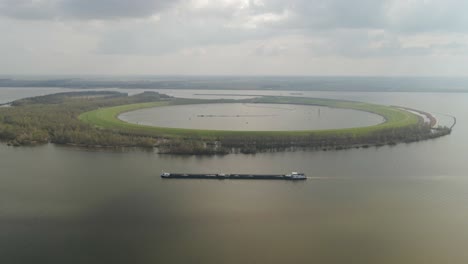 Inland-cargo-ship-vessel-moving-past-IJsseloog-in-Dutch-Ketelmeer-lake