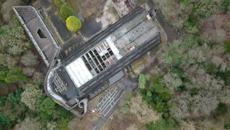 Aerial-top-down-rising-over-St-Peter's-Seminary-abandoned-building-near-Cardross,-Scotland