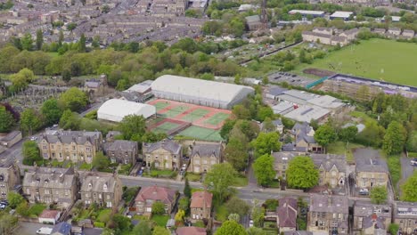 Aerial-drone-flyover-shot-of-a-tennis-club-and-courts-in-English-housing-estate