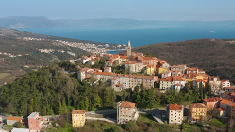 Beautiful-Labin-ancient-town-on-Croatian-coast,-aerial-arc-shot