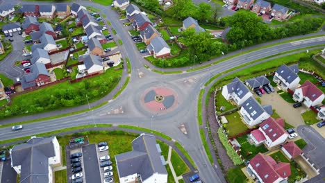 Aerial-view-of-road-traffic-roundabout-in-urban-residential-area