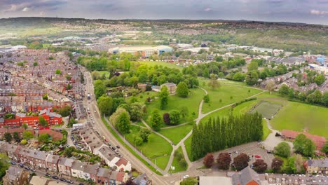 Beautiful-aerial-shot-of-a-British-town-with-green-fields-and-rolling-hills