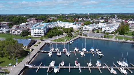 Historic-town-waterfront-marina-with-new-condo-building-developments-and-sail-boats-moored-at-docks