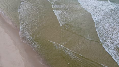 White-Water-Waves-Rolling-Gently-Into-The-Perfect-Sands-Of-Kingscliff-Beach-In-New-South-Wales,-Australia---aerial-top-down-shot