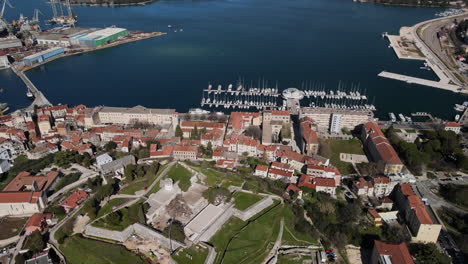 Aerial-of-Pula-Harbor-in-Croatia,-old-roman-forum-with-boats-docked
