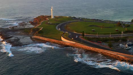 Aerial-view-of-Flagstaff-Point-Lighthouse-At-The-Headland-Of-Wollongong-Beach-at-Sunrise,-NSW,-Australia