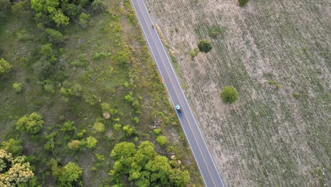 Aerial-Drone-Footage-Looking-Down-Tilting-Camera-Overlooking-Road-and-Vehicle-in-Lopburi-province,-Thailand