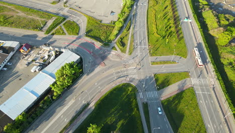 Aerial-shot-of-intersection-in-suburb-area-of-Gdansk-and-parking-place-during-sunlight,Poland