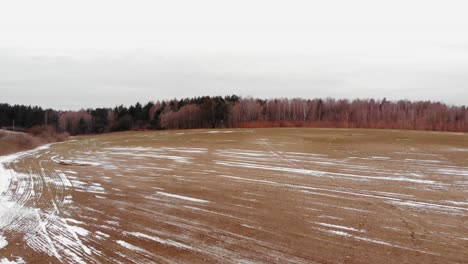 Vast-And-Vacant-Land-Partially-Covered-With-Snow-In-Buszkowy-Gorne,-Gdansk-County,-Poland
