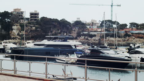 Luxury-yachts-and-catamaran-moored-in-the-harbor-on-Portochristo-in-Mallorca
