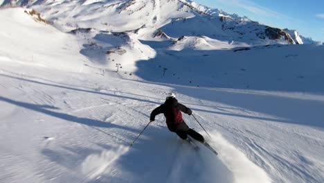 High-speed-ski-turns-on-a-steep-ski-slope-in-a-glacer-ski-resort-high-up-in-the-alps-with-fresh-snow