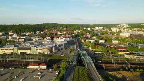 Aerial-view-showing-Gdansk-Cityscape-with-driving-cars-and-train-station-during-sunset-in-Poland
