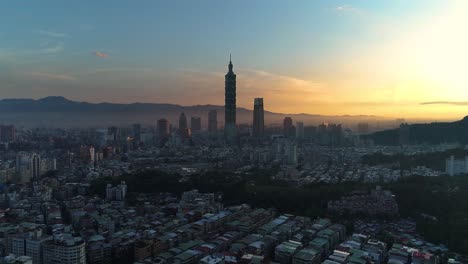 Epic-aerial-over-Tapei-City-Skyline-with-silhouette-of-Tower-101-during-epic-blue-hour-and-golden-sunrise
