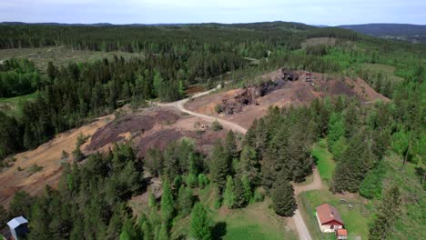 Circling-Over-Abandoned-Mine-In-Bergslagen-and-Vast-Forest-Landscape,-Industrial-Heritage,-Aerial