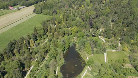 Aerial-of-beautiful-large-park-with-a-pond-and-trails