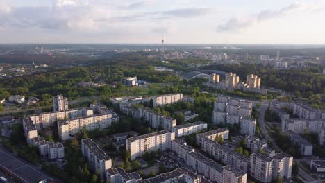 AERIAL-Panoramic-Shot-of-a-Soviet-Planned-Residential-District-Seskine-with-TV-Tower-in-the-background-in-Vilnius,-Lithuania